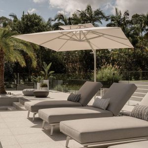 Chic and durable outdoor furniture set including a sofa, chairs, and a table, arranged on a patio surrounded by greenery.