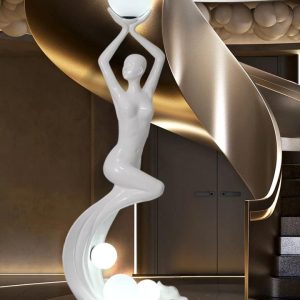 Elegant figurine floor lamp illuminating a stylish living room.