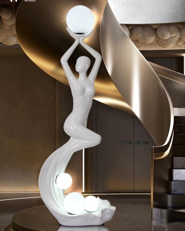 Elegant figurine floor lamp illuminating a stylish living room.